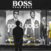 man standing in front of Boss Hugo Boss store