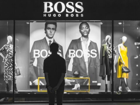 man standing in front of Boss Hugo Boss store