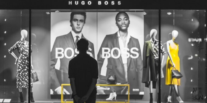 man standing in front of Boss Hugo Boss store