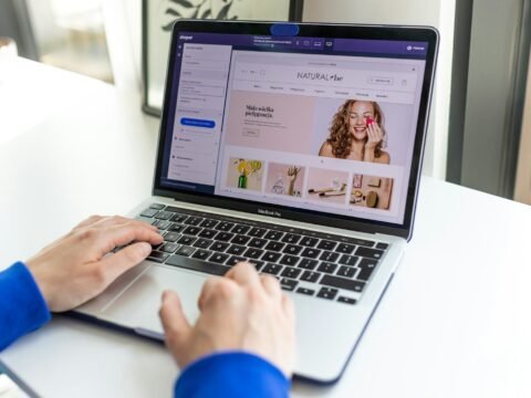 a person using a laptop computer on a table